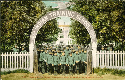 group photo of students at the gate of an American Indian boarding school