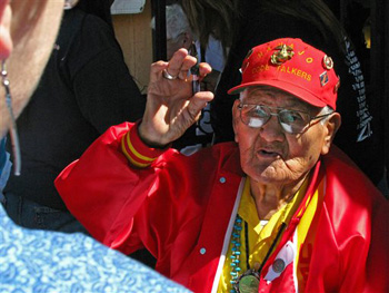 This Oct. 3, 2009, file photo, shows Navajo Code Talker Chester Nez speaking to a woman outside an Albuquerque, N.M., tourist shop during a book signing event for "Navajo Weapon." Nez, the last of the 29 Navajos who developed an unbreakable code that helped win World War II, died Wednesday morning, June 4, 2014, of kidney failure at his home in Albuquerque. He was 93.