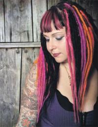 Woman with tatoos and color dreadlocks