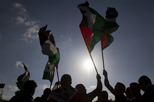 In this March 30, 2012 file photo, Arab Israeli protesters wave Palestinians flags as they gather to mark the annual Land Day event in the Arab Village of Dir Hana, northern Israel. There are about 2,000 Israel's flourishing tech industry, but estimates put the number of Arabs in the industry at some 1,600, a jump from 350 workers in 2008 but still only about 2 percent of all Israeli tech workers.