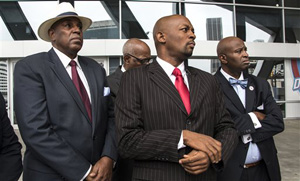 Rev. Markel Hutchins, foreground, listens to a reporter's question in front of Philips Arena in Atlanta Monday, Sept. 8, 2014. Civil rights leaders in Atlanta say they will ask for a meeting with Atlanta Hawks officials after the disclosure of a racially charged email written by the basketball team's co-owner. Hutchins said that he would ask for a meeting to discuss what he believes is a racist attitude permeating the organization.