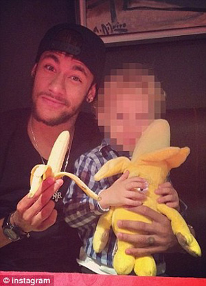 Barcelona teammate Neymar posted a photo of himself on Instagram holding a peeled banana alongside his son, who was holding a doll that resembled a banana.