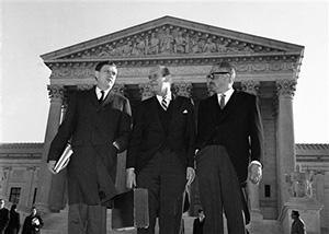 In this Jan. 17, 1966 file photo, Assistant Attorney General John Doar, left, stands with Attorney General Nicholas Katzenbach, center, and Solicitor General Thurgood Marshall as they arrive at the Supreme Court building in Washington to defend the legality of the 1965 Voting Rights Act.