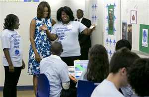 Annie Willis, right, introduces first lady Michelle Obama to members of Global Kids, at Baruch College, in New York, Thursday, July 10, 2014. Global Kids works to develop youth leaders through global education and leadership development programs.