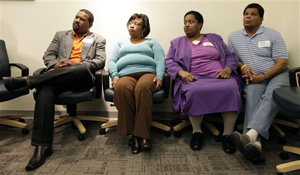 In this April 17, 2013 file photo, plaintiffs in a class-action racial bias lawsuit, from left: Charles Zanders; Teresa Jefferson; Beverly Couch and Wilbur Devine Jr., look on during a news conference in Des Moines, Iowa. The Iowa Supreme Court rejected the lawsuit Friday, July 18, 2014 that alleged the Iowa executive branch systematically discriminated against black job applicants.