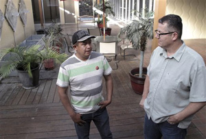 In this April 23, 2014 photo, farmworker Severiano Salas, left, speaks with United Farm Workers National Vice President Armando Elenes in Fresno, Calif. The United Farm Workers is in battle with Gerawan to represent thousands of his workers at his family farm.
