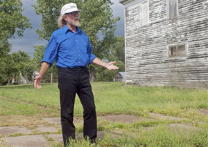 In this Aug. 26, 2013 photo, Craig Cobb stands in an empty lot he owns in Leith, N.D. The white supremacist who is seeking to take over the small North Dakota town is representing himself against federal terrorizing charges.