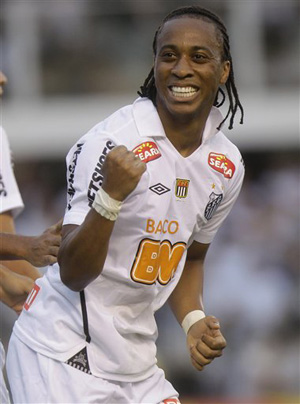 In this May 15, 2011 file photo, Santos' Arouca celebrates after scoring against Corinthians, during their Sao Paulo league soccer final match, in Santos, Brazil. Arouca was on the field talking to reporters after his team's 5-2 win in the Sao Paulo state championship on Thursday when some fans in the stands called him &quot;monkey.&quot;
