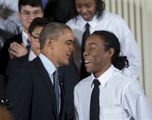 President Barack Obama speaks with Christian Champagne, 18, a senior at Hyde Park Career Academy in Chicago, who introduced him before launching a new initiative to provide greater opportunities for young black and Hispanic men called 'My Brother's Keeper'.