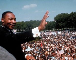 Martin Luther King, Jr. waves crowd