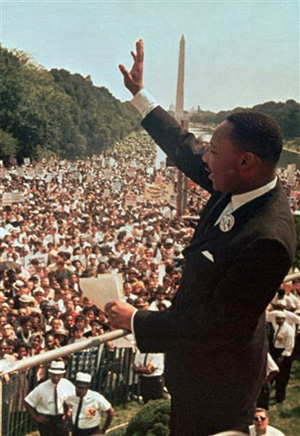 Martin Luther King, Jr. waves to the crowd during the original March On Washington