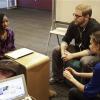 English teacher Tom Rademacher talks with his high school juniors Kierra Murray, left, and Ana Silverman, right, Tuesday, Dec. 2, 2014, at Fair School in Minneapolis. Knowing that the grand jury decision not to indict a white officer who shot and killed a black teen in Ferguson, Mo., would be on the minds of his students, Rademacher put aside his lesson plans and asked them a question: How did they feel?