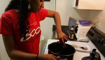 the author stirring a pot atop an oven