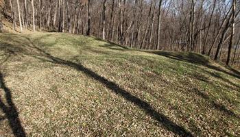 This Nov. 8, 2010, file photo shows the "Three Mounds" site at Effigy Mounds National Monument in Harpers Ferry, Iowa. Records show that National Park Service officials approved $3 million in illegal construction projects over a decade that damaged one of the nation’s most sacred Indian burial sites.