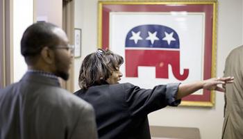 This photo taken May 19, 2014, shows former Republican candidate for Congress, Vivian Childs, right, walking through the Georgia GOP headquarters, followed by Michael Roundtree, chairman of the Morehouse College Republicans, before a training session with Leo Smith, minority engagement director for the Georgia Republican Party, not shown, in Atlanta.