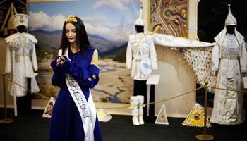 In this photo taken Friday, Feb. 14, 2014, Bella Kukan, Miss Circassia from the town of Maikop, waits to greet visitors during a folk theatre troupe performance at the Circassian House in Olympic Park at the 2014 Winter Olympics in Sochi, Russia. The Circassians, an ethnic group indigenous to the land now hosting the Olympics, are using the games to call the world’s attention to their culture and history, which includes massacres by imperial Russian armies and persecution by Stalin.