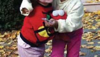 Two Asian-American girls smiling and playing