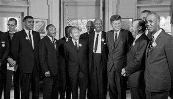 In this Aug. 28, 1963 file photo, President Kennedy stands with a group of leaders of the March on Washington at the White House in Washington. Immediately after the march, they discussed civil rights legislation that was finally inching through Congress.