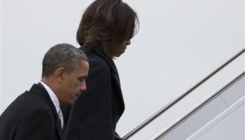 President Barack Obama and first lady Michelle Obama board Air Force One to travel to South Africa for a memorial service in honor of Nelson Mandela on Monday, Dec. 9, 2013 in Andrews Air Force Base, Md.