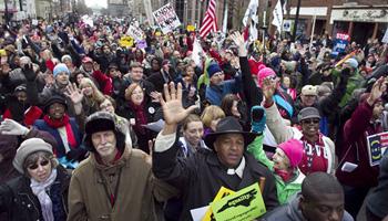 Rev. Jerry Dowdy of Carthage, N.C. sings with thousands of others at the "Moral March on Raleigh" on Fayetteville Street in Raleigh on Saturday, Feb. 8, 2014. Nearly 200 organizations are joining the National Association for the Advancement of Colored People in the "Moral March on Raleigh," a new name for the "Historic Thousands on Jones Street," as it was originally called. Jones Street referred to the street where the Legislative Building stands and the usual terminus of the march.