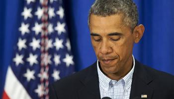 President Barack Obama pauses as he speaks about the situation in Ferguson, Mo., Thursday, Aug. 14, 2014, in Edgartown, Mass., during his family vacation on the island of Martha's Vineyard.