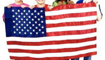 children of various ethnicities holding an American flag