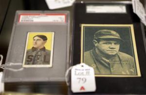 In this photo made Tuesday, March 11, 2014, baseball cards of major leaguers Harry Howell, left, and Babe Ruth are seen at the Saco River Auction House in Biddeford, Maine. The auction house is getting a reputation for selling some of the nation's oldest baseball memorabilia.