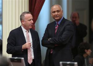 Senate President Pro Tem Darrell Steinberg, D-Sacramento, left, talks with Sen. Ed Hernandez, D-Covina at the Capitol in Sacramento, Calif., Monday, April 21, 2014. Hernandez proposed a constitutional amendment that would ask voters to again allow public colleges to use race and ethnicity when considering college applicants. The proposal stalled this year after backlash from Asian Americans.