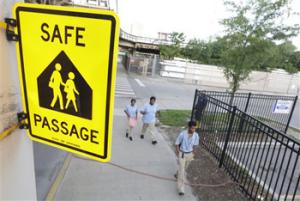 School Children walk a safe passage route along 63rd Street on the opening day of school this week, in Chicago. Chicago children returned to school walking past even more guards than last year, when concerns about safety prompted the city to line the streets with 1,200 adults every day.