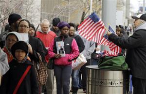 In this Nov. 5, 2012, file photo, voters wait in line outside the Cuyahoga County Board of Elections in Cleveland on the final day of early voting. Early voting won't be starting in Ohio on Tuesday, Sept. 30, 2014, following an order from a divided U.S. Supreme Court that delayed it until next week.