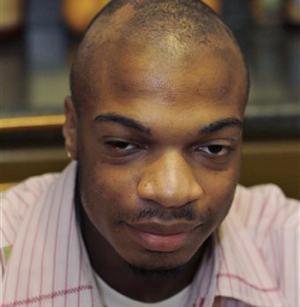 This Jan. 22, 2010 file photo shows Jordan Miles in his home in Pittsburgh, shortly after being beaten and arrested by thee plainclothes police officers who claim they mistook a soda bottle for a weapon.