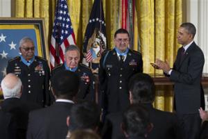 President Barack Obama applauds, from left, Staff Sgt. Melvin Morris, Sgt. 1st Class Jose Rodela, and Spc. Santiago J. Erevia after he awarded them with the Medal of Honor during a ceremony in the East Room of the White House in Washington, Tuesday, March 18, 2014.