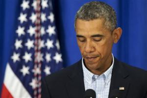 President Barack Obama pauses as he speaks about the situation in Ferguson, Mo., Thursday, Aug. 14, 2014, in Edgartown, Mass., during his family vacation on the island of Martha's Vineyard.