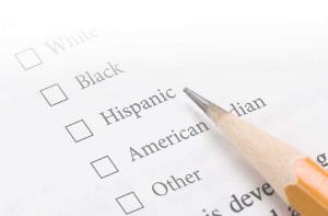 a list of ethnicities on paper with a pencil