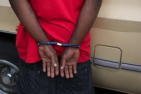 African-American youth in handcuffs