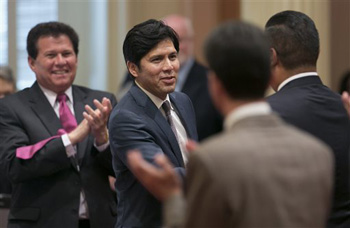 Senator Kevin de Leon, Democrat from Los Angeles, second from left, receives congratulations from other lawmakers after he was elected as the new Senate President Pro Tem at the Capitol in Sacramento, Calif., Monday, June 16, 2014. De Leon will become just the second Latino leader of the Senate, but the first in more than 130 years.