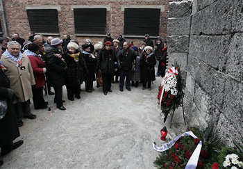 Auschwitz survivors lay a wreath at the former Nazi death camp Wall of Death in Oswiecim, Poland, on Monday, Jan. 27, 2014, to mark 69 years since the Soviet Red Army liberated the camp. Israeli lawmakers and government officials are to attend anniversary observances later in the day. The Nazis killed some 1.5 million people, mostly Jews at the camp during World War II.