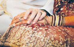 henna-tattooed hand of a bride