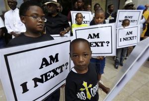 African-American boys holdings signs - &quot;Am I Next&quot;