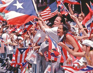 Latinos waving US and Cuban flags