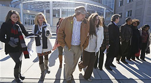 Robert Henry Rice, third from left, walks past news reporters and the family of James Craig Anderson on right, as he exits the federal courthouse in Jackson, Miss., Wednesday morning, Jan. 7, 2015, for his change-of-plea hearing in relation to a series of 2011 racial beatings that resulted in Anderson's death.
