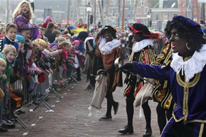 In their jester-like costumes, with gold hoop earrings and curly black hair, Black Petes are often played by performers in blackface. This has led to many black children being cruelly taunted by their peers, with cries of &quot;When are you going to entertain us?&quot; and similar jabs quite common.