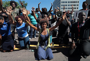 Some protesters Wednesday raised their arms above their heads as they faced the police. Others held signs asking for answers about Brown's death. The most popular chant has been, &quot;Hands up! Don't shoot!&quot;