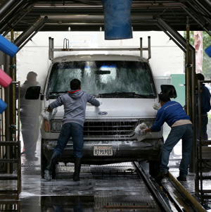 Car wash mogul acknowledges that he knowingly turned a blind eye to the hiring of more than 200 unauthorized immigrants. The bust by U.S. Immigration and Customs Enforcement reflects a new approach by federal authorities in confronting employers suspecting of hiring people who aren't legally in the country.