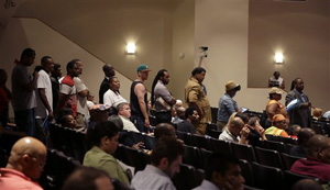 In this Sept. 9, 2014 file photo, a line of people wait to speak during a meeting of the Ferguson City Council in Ferguson, Mo. It was the first for the city council after the fatal shooting of Michael Brown by a city police officer. Voting continues to be struggle in Ferguson, a St. Louis suburb.