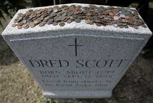 Just a few miles from where Michael Brown died lies the gravestone of Dred Scott, a slave who unsuccessfully went to the Supreme Court to be recognized as a free American citizen. In this March 6, 2007 file photo, pennies were placed on the headstone on the 150th anniversary of the U.S. Supreme Court's decision to deny Scott his freedom. Pennies are placed to honor Lincoln's role in freeing the slaves.