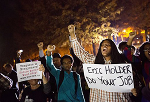 Protesters chant outside Ebenezer Baptist Church, the church where The Rev. Martin Luther King Jr. preached, as U.S. Attorney General Eric Holder speaks inside to members of the community during an interfaith service, Monday, Dec. 1, 2014, in Atlanta.