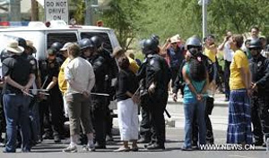 The protesters called for the end of enforcement of SB1070, also known as the &quot;show me your papers&quot; law. The law requires local police to check the immigration status of people they encounter while enforcing other laws.