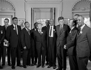In this Aug. 28, 1963 file photo, President Kennedy stands with a group of leaders of the March on Washington at the White House in Washington. Immediately after the march, they discussed civil rights legislation that was finally inching through Congress. The leaders pressed Kennedy to strengthen the legislation; the president listed many obstacles. Some believe Kennedy preferred to wait until after the 1964 election to push the issue.