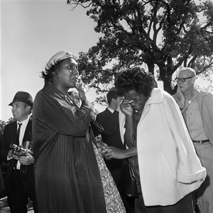 In this Nov. 22, 1963 file photo, women burst into tears outside Parkland Hospital upon hearing that President John F. Kennedy died from a shooting while riding in a motorcade in Dallas. Looking at why so many black people revered him then - and why younger generations have largely forgotten his civil rights work now - shows that even 50 years later, Kennedy holds a complicated but pivotal place in black history. Photo Credit: The Associated Press, Photo File.